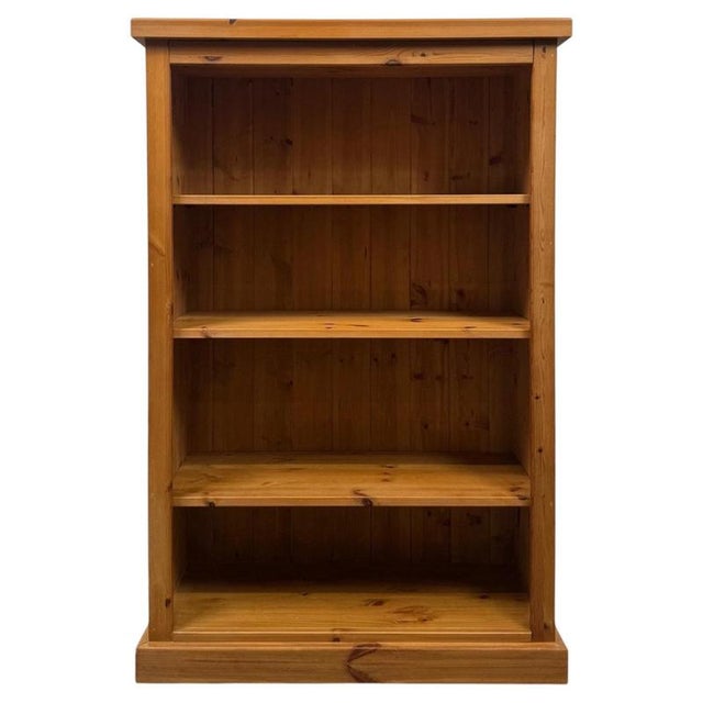 A handsome and highly practical vintage 20th-century open bookcase, well constructed in pine and distinguished by its...