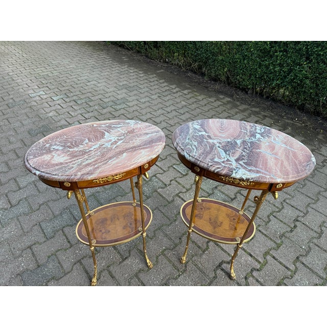 Bring timeless French sophistication into your interior with this elegant pair of Louis XVI-style side/center tables,...