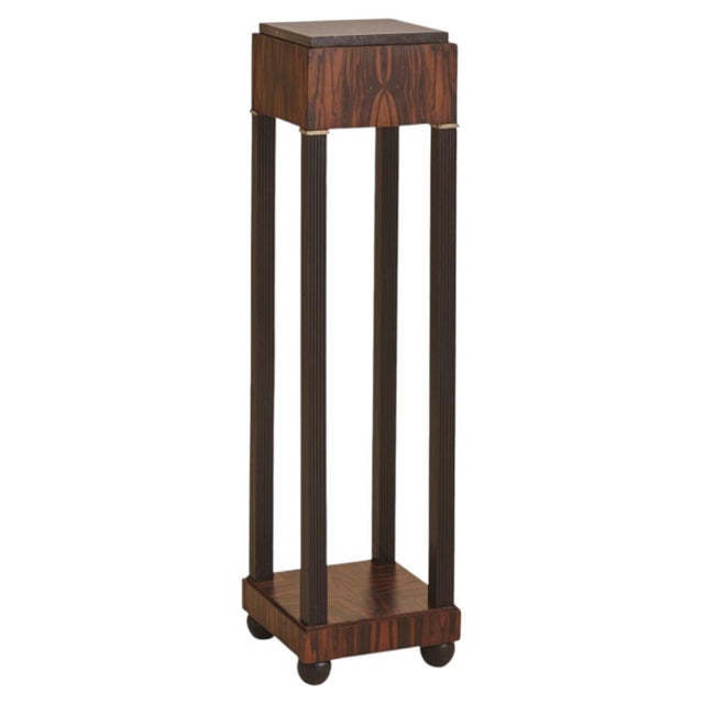 A French Art Deco pedestal from the 1940s, distinguished by its rosewood veneer. The square top is capped with a veined...
