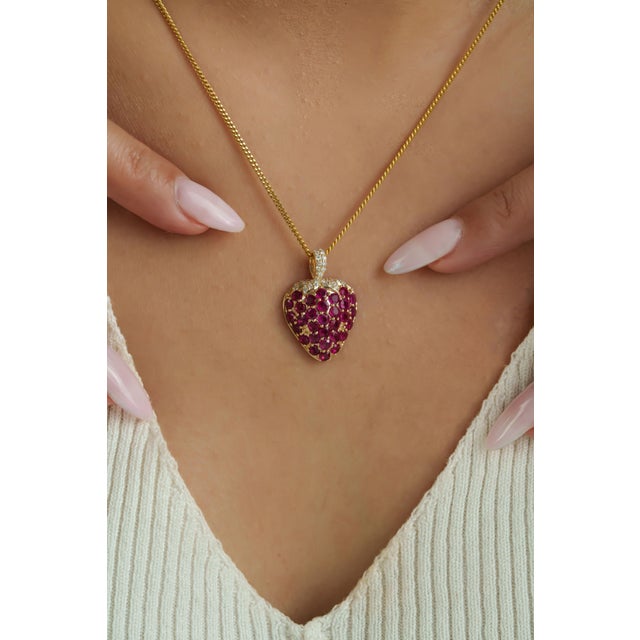 This whimsical strawberry pendant features 2.55 carats of rubies set in 14K yellow gold. Each ruby measuring approximately...