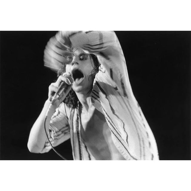 Mick Jagger caught mid-performance. The camera lens closes and Jagger's hand is still moving, lending a dynamism to this...
