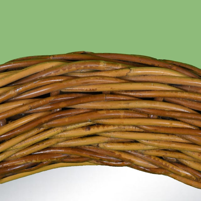 An oval mirror wrapped in braided rattan, a soft organic shape that warms up any wall. The braided texture adds artisanal...