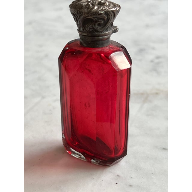 19th-century Victorian cranberry cut glass perfume bottle with an ornate repoussé sterling silver hinged cap. Includes...