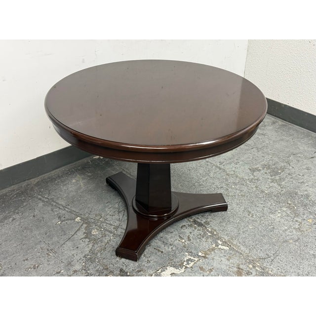 Design Plus Gallery presents a Plaza Table from Nancy Corzine. This round pedestal table shows the label’s polished...