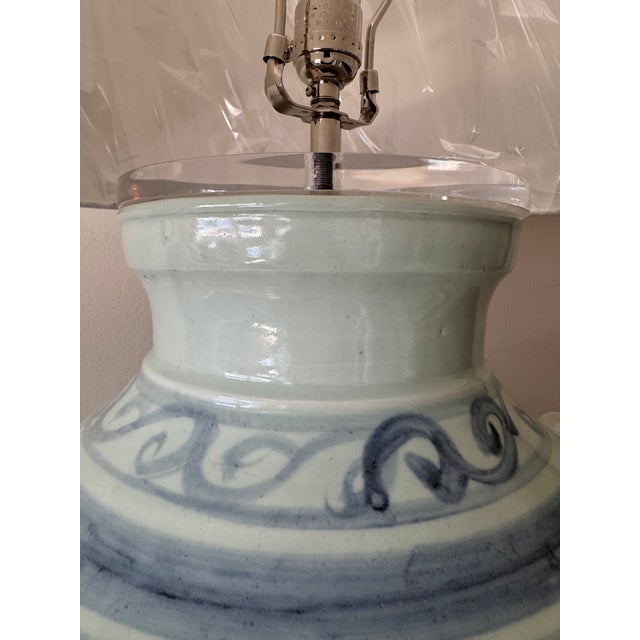 Oversized double lion handle ceramic lamps in blue & white with fish accents on acrylic base. Never used, electrical...