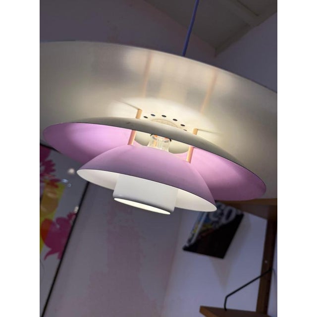 This louvered lamp from Formlight in Denmark skillfully plays with form and color: Five layered louvers combine to create...