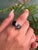 This elegant two-stone ring is crafted from 925 Sterling Silver and features the timeless beauty of oval-cut garnets. Each...