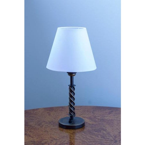 Swedish modern table lamp in antique oxidized brass. Made in Sweden during the 1930-40s. Spiral shaped handle with...