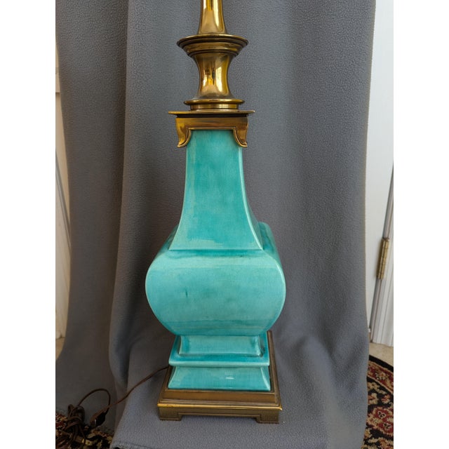 Mid-century Stiffel Hollywood Regency Style. Teal green glazed ceramic with brass trim. Milk glass like torchiere.