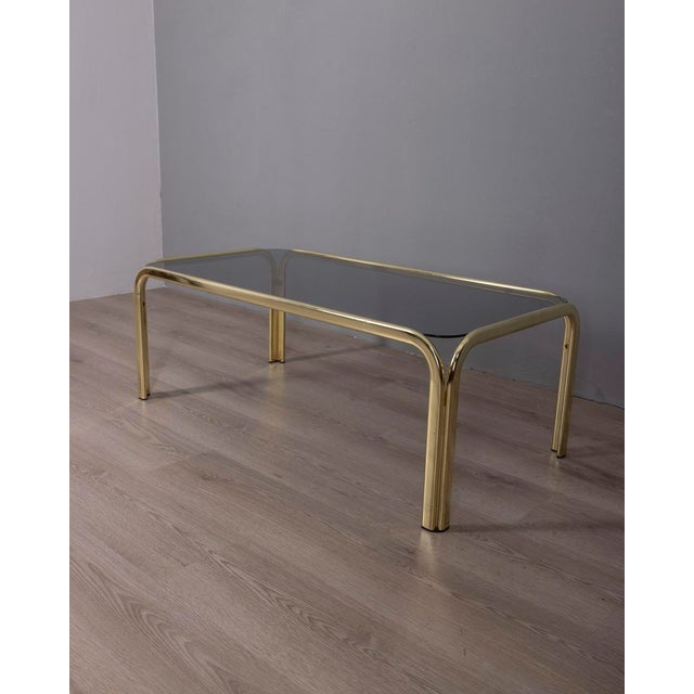 Coffee table with gilded brass structure with rounded corners and smoked glass top, Italian design, 1970s.