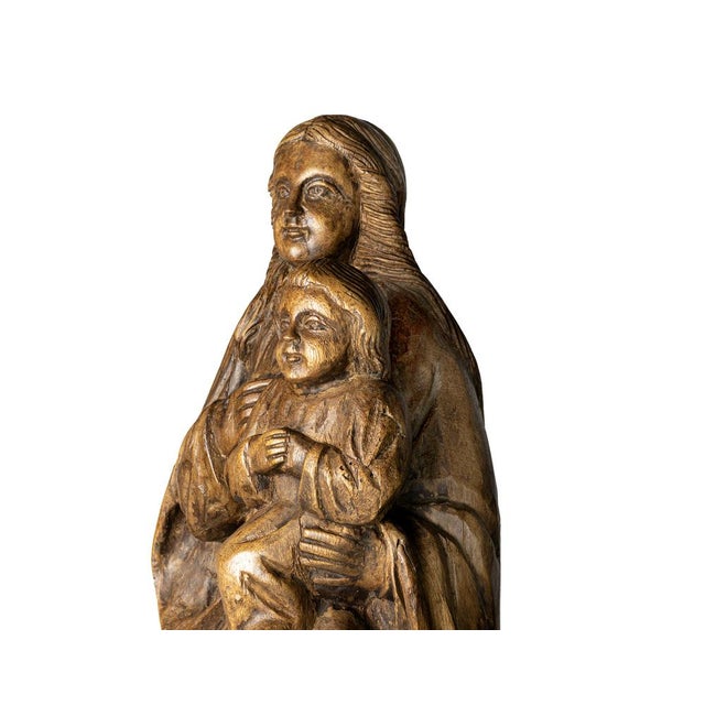 This captivating 20th-century wood sculpture depicts Our Lady holding the Child Jesus, crafted from warm wood with a...