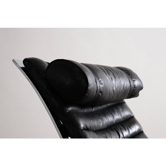 Stunning Ari lounge chair with ottoman in original black leather, designed by Arne Norell, and manufactured by Norell...
