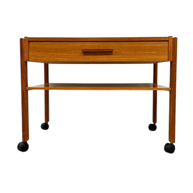 Elegant and functional, this vintage danish Modern rolling side table features clean lines and thoughtful craftsmanship...