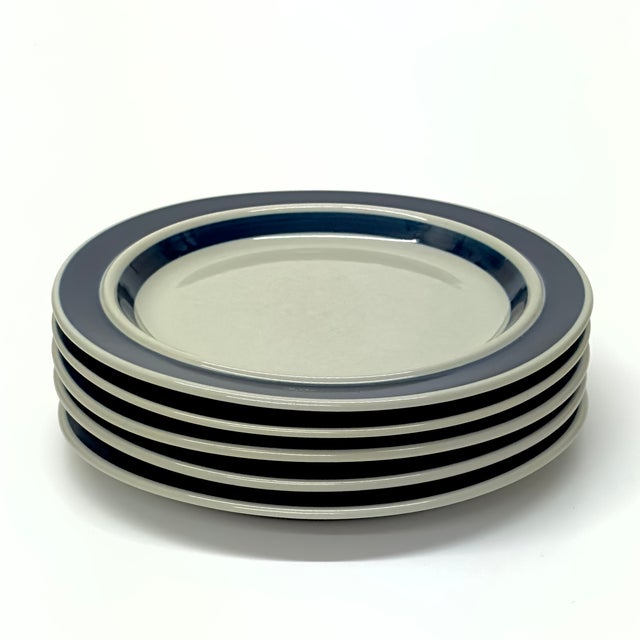 White and blue rim plates, group of 5. This set of five dinner plates was produced by Ulla Procopé for Arabia of Finland,...