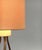 Mid Century tripod table lamp with shade. Very reserved in terms of shape and color. The lamp balances on 3 brass-colored...