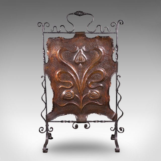 This is an antique fire screen. A French fireplace reflector in planished copper and wrought iron, dating to the late...