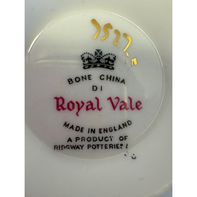 A refined English bone china teacup and saucer by Royal Vale, a Ridgway Potteries line, decorated with a graceful forget-...