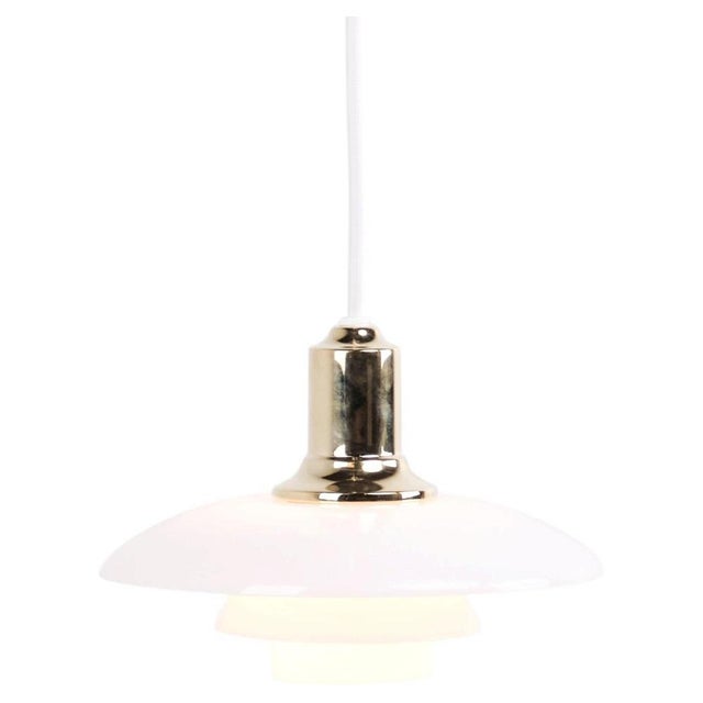 Ph 2/1 pendant in brass with opal glass from louis poulsen. Designed by poul henningsen with classic danish lighting...