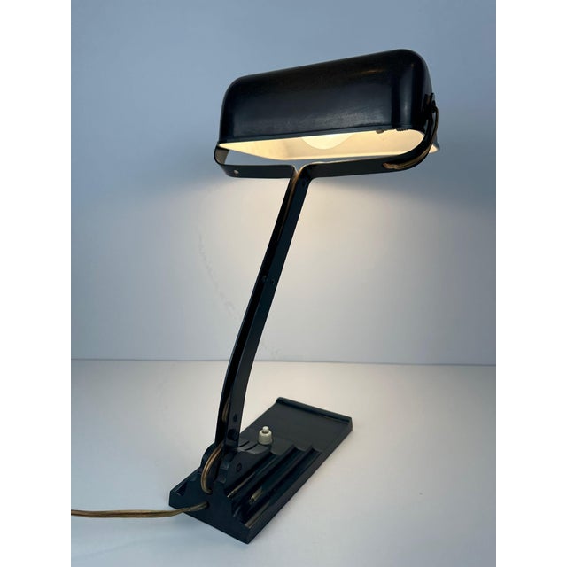An ERPE notary lamp. Model 52. Cast iron base. Bakelite movable shade on a movable arm. No cracks. Copper/porcelain E27...