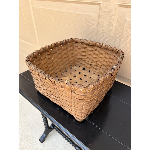 A beautifully woven early 20th century American splint oak basket with warm honeyed tones and a tightly constructed...