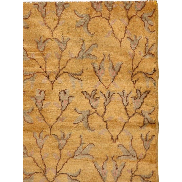 This mid-20th-century Turkish Anatolian rug presents an elegant allover botanical design across a warm ochre and golden-...