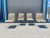 This glamorous set of four mid-century dining chairs by Design Institute of America (DIA) perfectly blends Hollywood...
