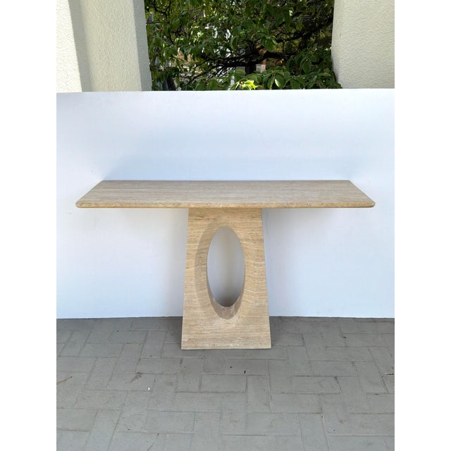 Stylish Currey & Co Demi Travertine Console Table. Sculptural Base with oval design. Original Retail $7490. Showroom Floor...
