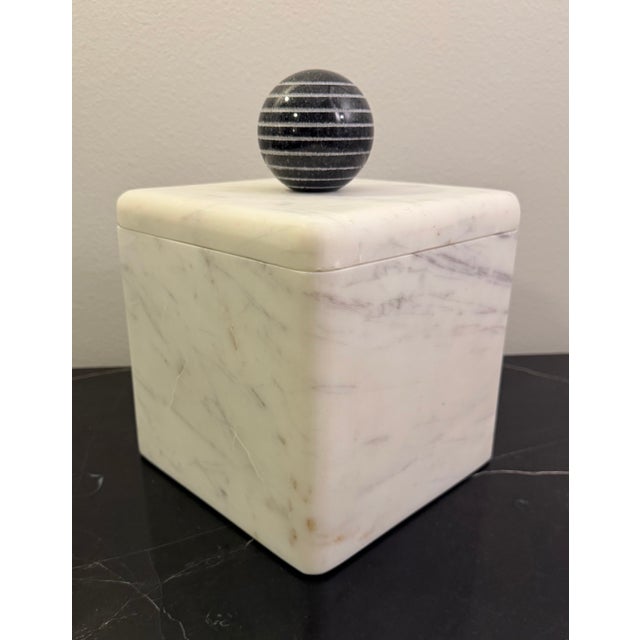 This stunning white marble box topped with a carved black marble sphere designed by Citizen Artist (formally Form Design...