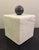 This stunning white marble box topped with a carved black marble sphere designed by Citizen Artist (formally Form Design...