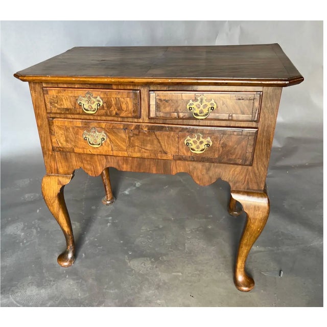 Great little 18th century English burl walnut and oak lowboy on cabriole legs and pad feet. This beauty features an...