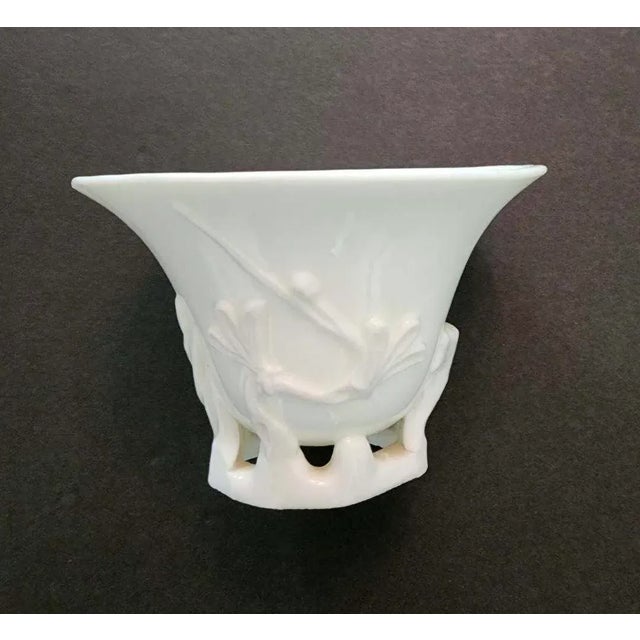 Late 19th/early 20th C. libation-form blanc de Chine petit vase. Features plum blossoms on front and delicate abstracted...