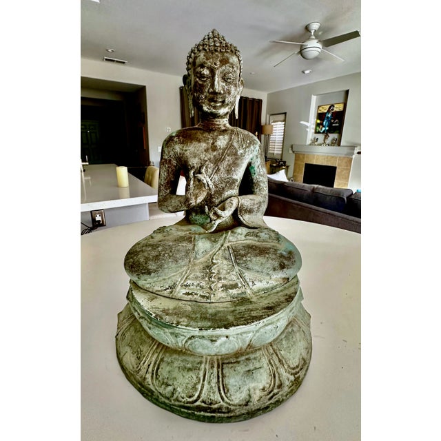 Asian patinated brass or bronze seated Gandhara Style Buddha with both hands raised in the vitarka mudra or teaching hand...