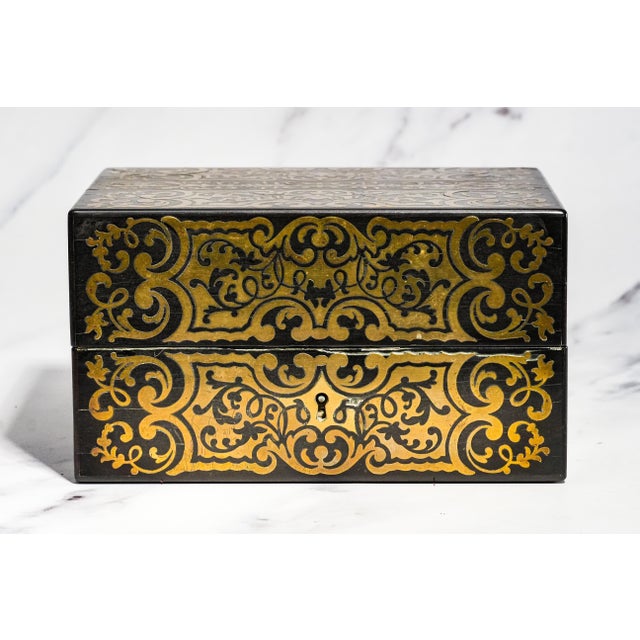 This exceptional mid-19th-century ebonized wood and brass-inlaid dressing box is a superb example of the luxurious...