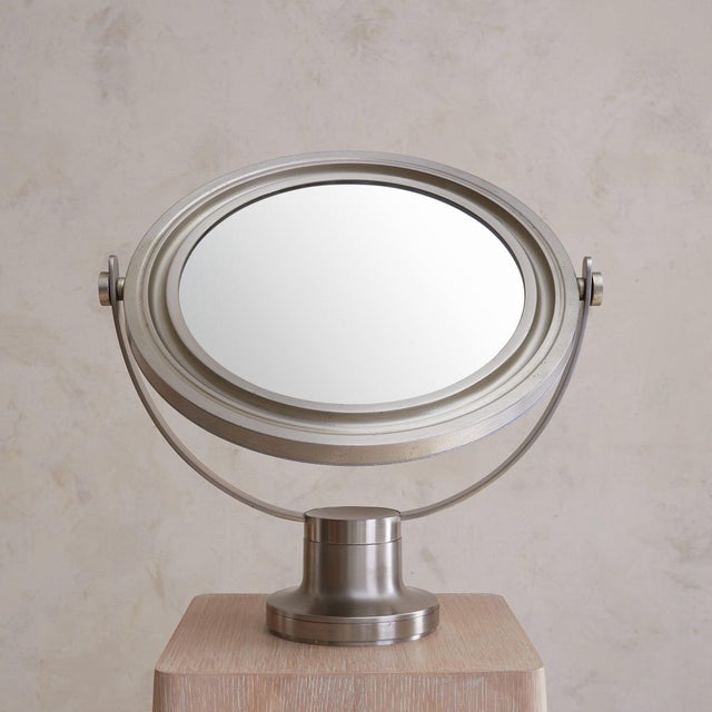 A 1960s Italian table mirror attributed to Sergio Mazza for Artemide. Cast in nickel-plated metal, the round mirror floats...