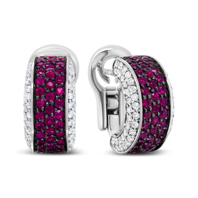 These huggie earrings provide stunning sparkle in the form of round white diamonds in prong settings and bring about a...