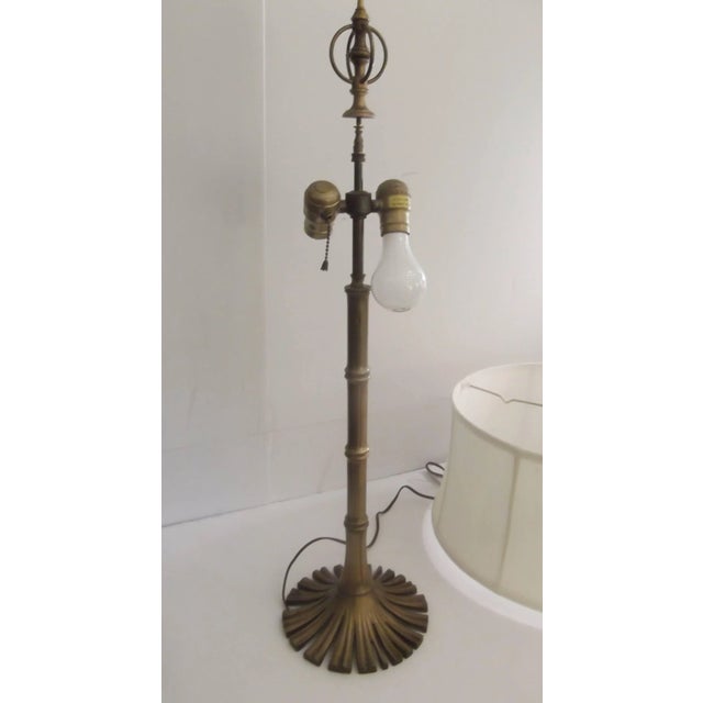 Decorator lamp made by the Chapman lamp company. Solid cast brass with a bamboo motif body resting on a circular fan of...