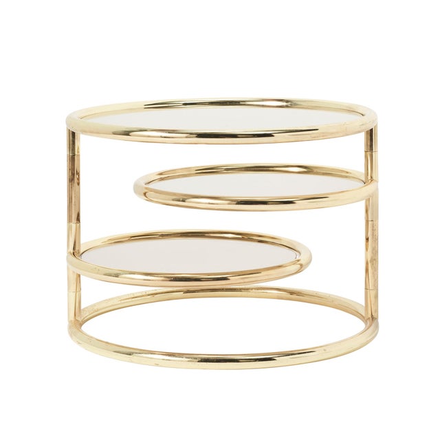 This mid-century modern brass end table includes three tiered shelves that swivel. 1st Tier Glass- 22.5" 2nd Tier Glass-...