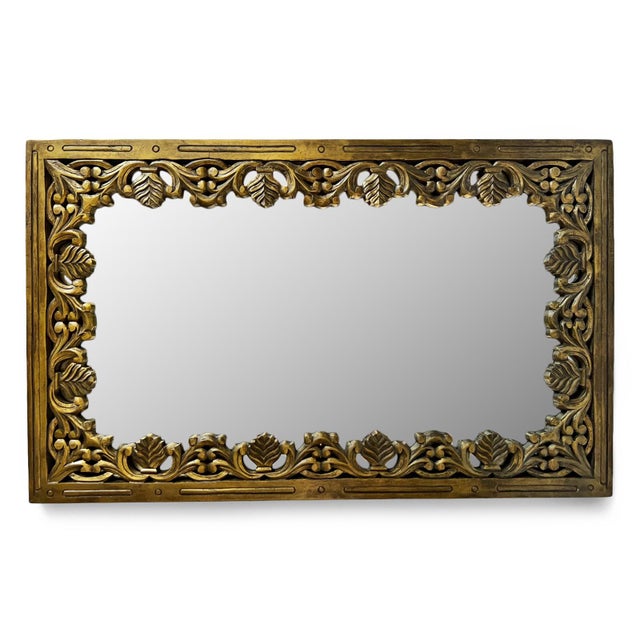 Beautiful vintage carved teak wood floral design mirror. Bronze/gold toned finish and impressive hand carved details. Can...