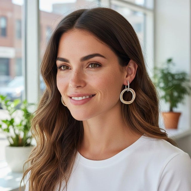 A striking celebration of artistry and symbolism, these intertwining circle drop earrings are crafted in a luxurious mix...