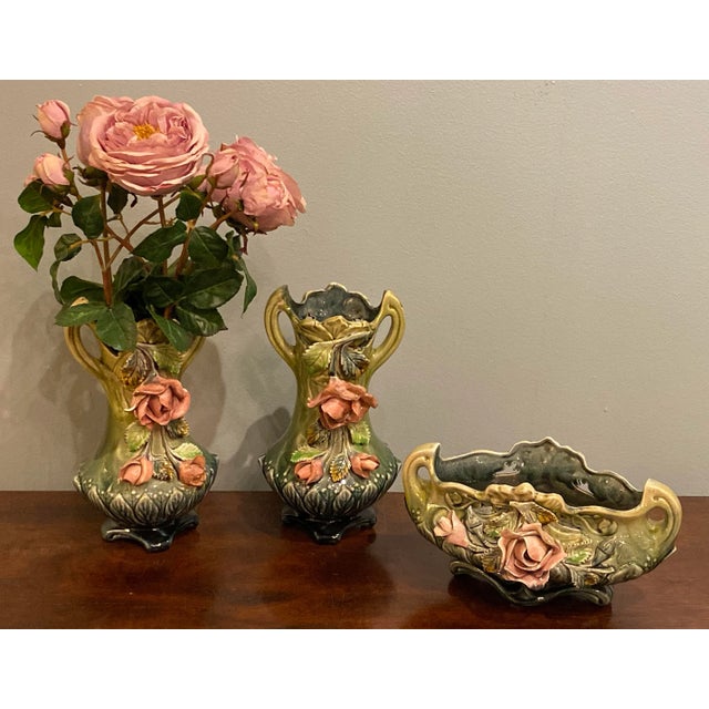 Majolica three piece planter set with a majolica rose cache pot and a pair of vases. Vases 6” Wide x 4.25” Deep x 12” High...
