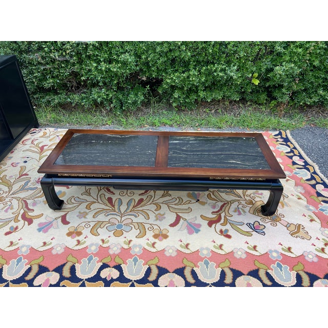 A fantastic ebonized wood bottom with Asian fretwork separating it from the walnut top with black marble inserts. The...