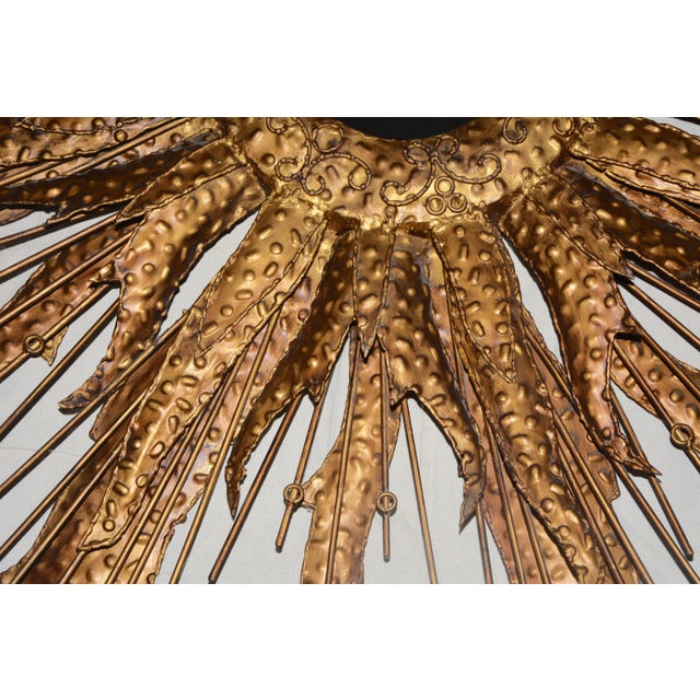 Featured is a fabulous, handcrafted sunburst wall mirror. The mirror is round in shape and features a metal frame in a...