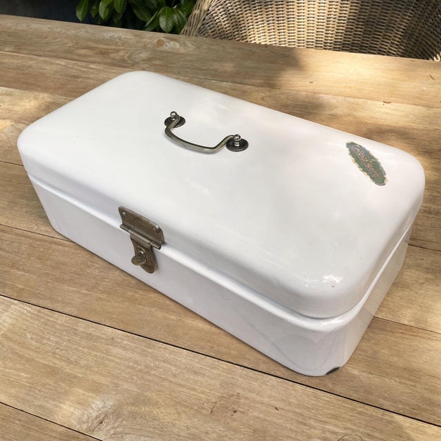 Vintage white enameled steel bread box from the 1950s, originating from the Netherlands. This charming box has a white...