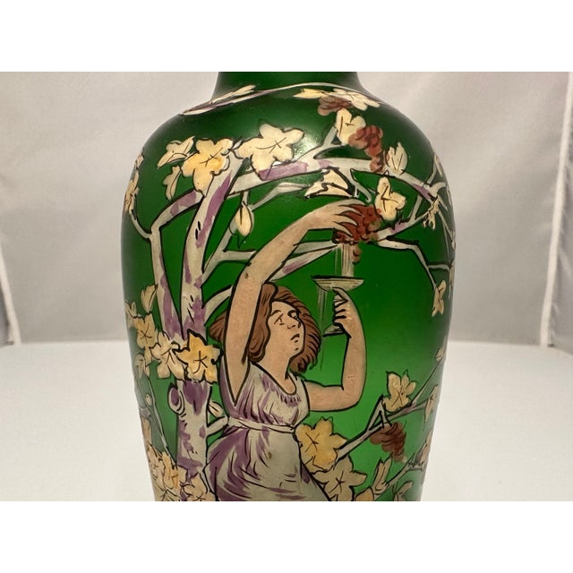Jugendstil Hand Painted Enamel Maiden Drinking Wine in Vineyard Art Glass Vase for your consideration. The vase measures...