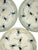 A charming set of four Bat Trang dessert plates featuring delicate hand-painted dragonflies scattered across a warm ivory-...