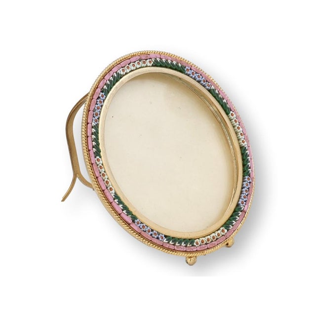 This Italian micromosaic picture frame features finely arranged glass tesserae in soft pastel tones, encircling a generous...