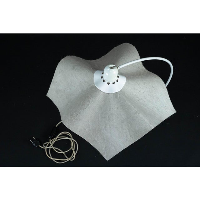 The area curva lamp by mario bellini is a distinctive vintage lighting piece that embodies the elegance and architectural...