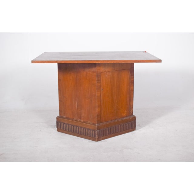 Table with base unit and door. with a unique design, the central base is robust and trapezoidal in shape, giving the...