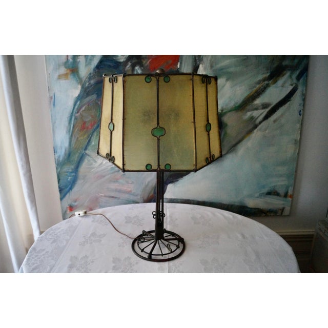 A truly unique art deco table lamp. France 1930s Iron base and the shade is a sort of early synthetic material. Lamp has...
