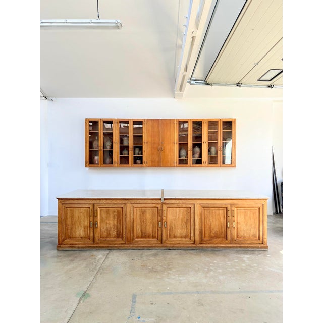 This antique pharmacy counter has survived over a century without losing an ounce of its character. Its solid chestnut...